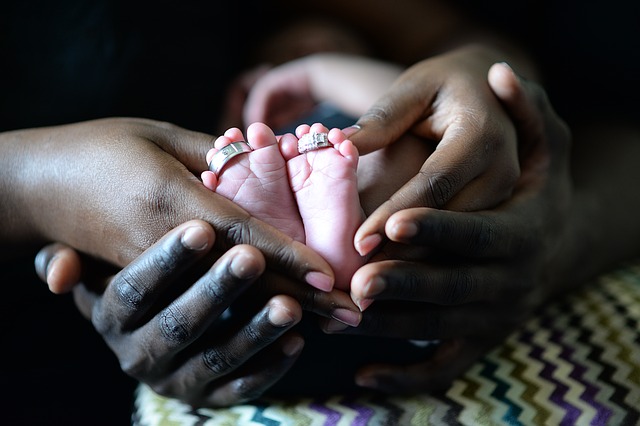 New-born baby feet in parents' hands